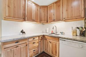 a kitchen with wooden cabinets and a sink at Tahoe Keys Marina View - 3 BDR Desirable Community in South Lake Tahoe