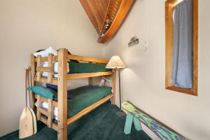a bunk bed in a room with a lamp at Tahoe Keys Marina View - 3 BDR Desirable Community in South Lake Tahoe
