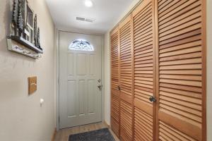 a hallway with a white door and a window at Tahoe Keys Marina View - 3 BDR Desirable Community in South Lake Tahoe