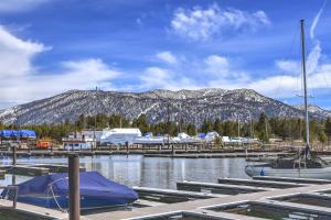 a marina with boats and a mountain in the background at Tahoe Keys Marina View - 3 BDR Desirable Community in South Lake Tahoe