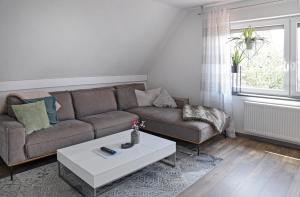 a living room with a couch and a coffee table at Ferienwohnung Ida in Xanten +12 photos