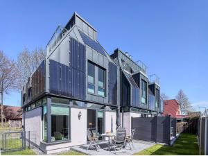 Una casa grande en blanco y negro con patio. en Kraanstiet 3, en Zingst