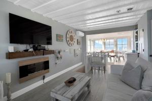 a living room with a couch and a table at Diana Luxury Retreat: Private Beach and Vineyards in Wading River +25 photos