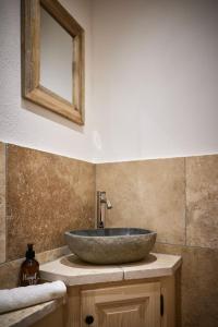 a bathroom with a stone sink on a counter at Ferienwohnungen Bergbleamal in Rottach-Egern +26 photos