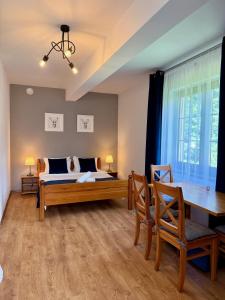 Posteľ alebo postele v izbe v ubytovaní Maya Pokoje i Apartamenty