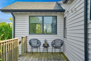 un portico con due sedie e un tavolo sopra di Chic Beach House: Waterfront, Vineyards, Hot Tub a Wading River
