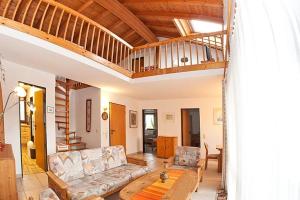 a living room with a couch and a table at Ferienhaus Gamssteige im Feriendorf Reichenbach G11 in Nesselwang +10 photos
