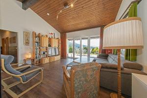 a living room with a couch and a table at Ferienhaus Gamssteige im Feriendorf Reichenbach G22 in Nesselwang +17 photos