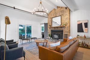a living room with a couch and a fireplace at Respite Ranch: Private Pool, Hot Tub, Beach Access in Mattituck