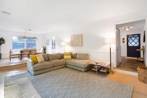 a living room with a couch and a table at Respite Ranch: Private Pool, Hot Tub, Beach Access in Mattituck