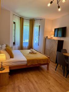 Posteľ alebo postele v izbe v ubytovaní Maya Pokoje i Apartamenty