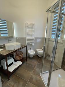 a bathroom with a toilet and a sink and a shower at Villa Lidya Malpensa in Gallarate +8 photos