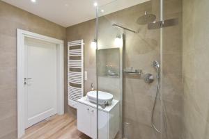 a bathroom with a shower and a sink and a shower at Apartament Aquarius Sopot in Sopot +19 photos