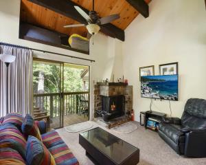 a living room with a couch and a fireplace at Enjoy Forest Views Retreat at Kingswood Village in Kings Beach
