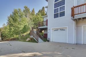 a house with a driveway and a garage at Mountain-View Conifer Gem Near Hiking and Fishing in Conifer