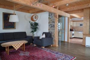 a living room with a couch and a table at Ferienhaus Fuchsweg im Feriendorf Reichenbach F24b in Nesselwang