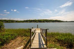 a wooden bridge over a body of water at Private Waterfront Home: Dock, Kayaks in Southold