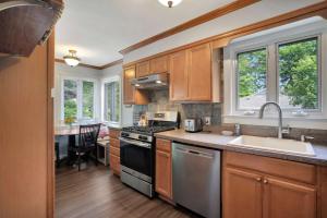 a kitchen with a sink and a stove top oven at Charming Cottage in The Heart of the North Fork in Jamesport