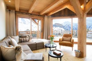 a living room with a couch and a chair at Chalet Les 3 Ours by Leavetown Vacations in Les Deux Alpes
