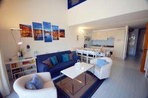 a living room with a couch and chairs and a table at Tartaruga in Caleri +9 photos