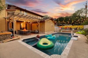 a swimming pool with a raft in the middle of a house at Sleeps 18-Basketball Court-Pool-Playground-Games in San Antonio
