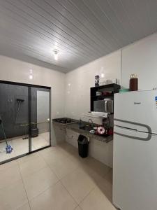 a kitchen with a refrigerator and a counter top at Residencial Roma in Palmas +32 photos