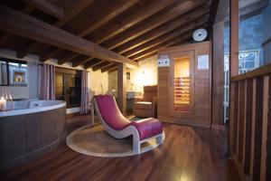 a bathroom with a tub and a chair in it at Casa Quimera in Gilgarcía