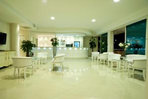 a dining room with white chairs and tables at Hotel Prater in Grottammare