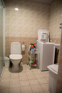 a bathroom with a toilet and a small refrigerator at Pärnu Karusselli Beach Apartment in Pärnu