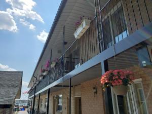 a building with potted plants on the side of it at Georgian Inn Motel in Wasaga Beach