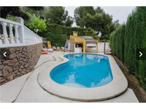 a large blue swimming pool in a yard at Chalet con piscina privada in Las Villas