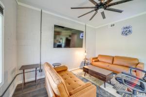 a living room with a couch and a table at 7 Mi to Dtwn Tulsa Dog-Friendly Home with Yard in Tulsa