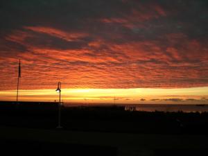 a sunset over the ocean with the sky at Haus am Meer, Hotel Garni in Helgoland +18 photos
