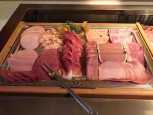 a tray of different types of meats and sausage at Haus am Meer, Hotel Garni in Helgoland