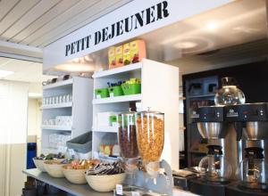 a kitchen with a counter with a food appliance at Premiere Classe Niort Est - Chauray in Niort