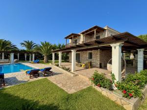 a house with a patio and a swimming pool at Villa Penelope Spartia Kefalonia in Spartià