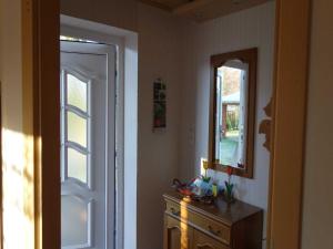 a room with a door and a dresser and a mirror at Ferienwohnung "Röwer" in Neu Gaarz +13 photos