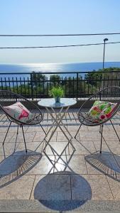 a table and two chairs sitting on a patio at Alba di Mare - Appartamento con Vista Mare in Andrano