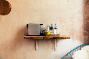 a shelf with a microwave on a wall at The Culpeper Bedrooms in London