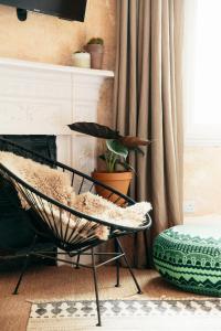 a chair with a teddy bear on it in a living room at The Culpeper Bedrooms in London