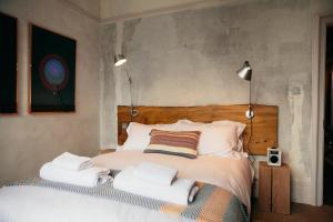 a bedroom with a bed with towels on it at The Culpeper Bedrooms in London