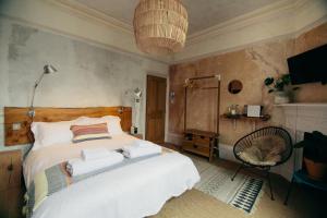 a bedroom with a bed with towels on it at The Culpeper Bedrooms in London