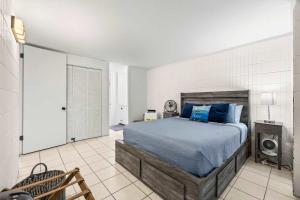 a bedroom with a bed with blue pillows at Amazing Beachfront Condo with AC in Laie +49 photos
