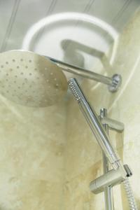 a shower with a strainer in a bathroom at The Culpeper Bedrooms in London