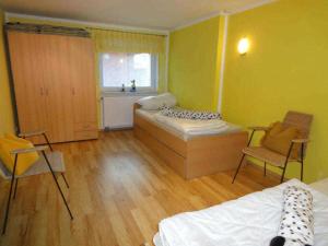 a room with two beds and two chairs in it at Ferienhaus Grüner Winkel - Nähe Strandstraße in Müritz