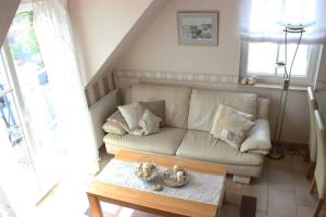a living room with a couch and a coffee table at Ferienwohnung Seeanemone I - GM 69353 in Graal