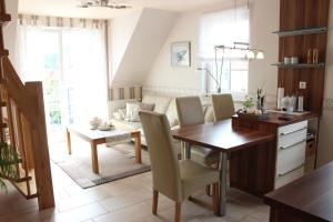 a kitchen and dining room with a table and chairs at Ferienwohnung Seeanemone I - GM 69353 in Graal