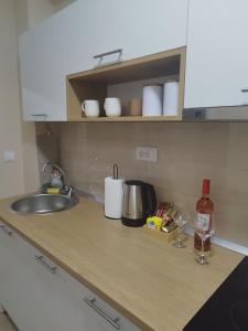 a kitchen counter top with a sink and a counter top at Jaz Apartman in Bajina Bašta +31 photos