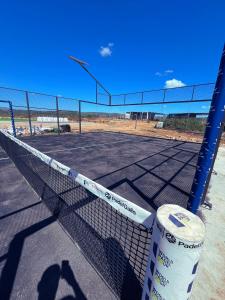 a tennis court with a net on a tennis court at Villa con piscina, campo fútbol y pádel in Mas dʼen Rieres