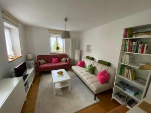 a living room with a couch and a table at Ferienhaus mit Garten und Balkon in Berching